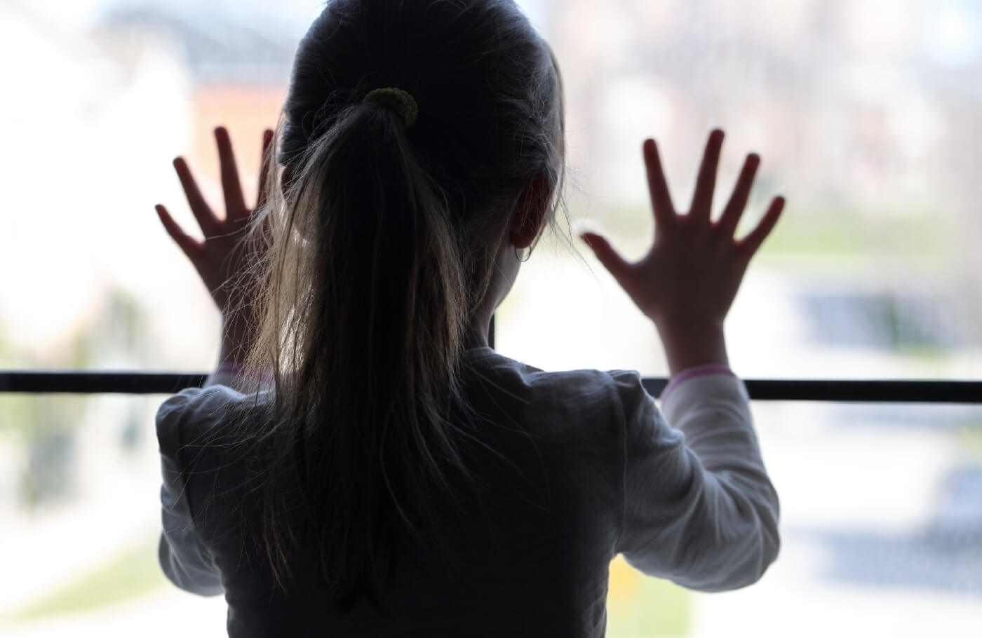 Little girl looking out the window.