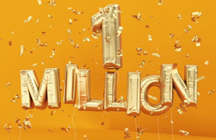 Golden balloons spelling out "1 million" against an orange background.